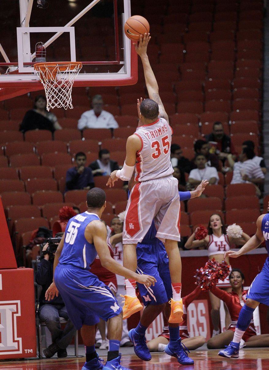 Houston's forward TaShawn Thomas (35) shoots over Memphis' Geron Johnson (55) during the first half of an NCAA college basketball game, Thursday, Feb. 27, 2014, in Houston. (AP Photo/Bob Levey)