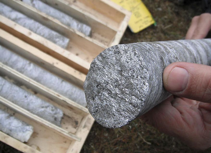 This July 2012 photo released by Graphite One Resources shows a technician holding a graphite core sample drilled near Graphite Creek, a mineral claim being explored by Graphite One Resources north of Nome, Alaska. A surge in prices in 2012 and the hope for expanded uses for graphite in electric car batteries has spurred exploration for high-grade flake graphite in North America and around the world. (AP Photo/Graphite One Resources, Dean Besserer)