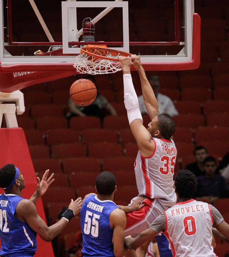Houston's forward TaShawn Thomas (35) dunks on Memphis' Geron Johnson (55) during the first half of an NCAA college basketball game, Thursday, Feb. 27, 2014, in Houston. (AP Photo/Bob Levey)