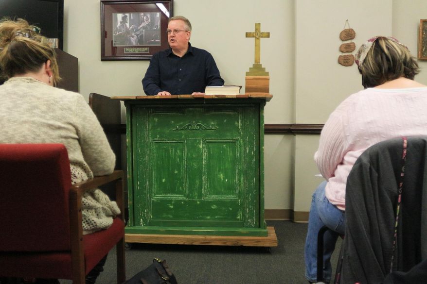 Dr. Dwight Lysne gives a sermon at Haven Ministries on Feb. 8, 2014 in Wilmington, N.C. Lysne specializes in treating patients with mental health issues. Many are addicted to opioids, drugs derived from natural or synthetic opium substances. They include prescription medicines and street drugs. He prescribes medication to ease their withdrawal symptoms. He leads church services, Bible studies and support groups to nurture their spiritual lives. Not all its members use the clinical services. (AP Photo/The Star-News, Jason A. Frizzelle)