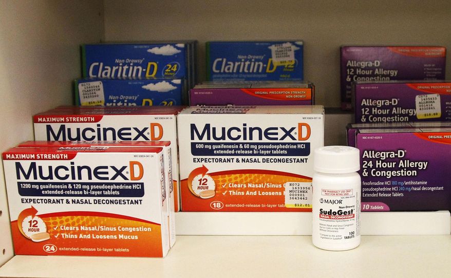 FILE - This July 19, 2010 file photo shows medications containing pseudoephedrine on display behind the counter of a pharmacy in Edmond, Okla. A bill proposed in the Illinois Legislature by a Peoria Democratic state Sen. Dave Koehler would require anyone to get a doctor's prescription to buy any cold and flu drug with pseudoephedrine. The decongestant is an ingredient used to make methamphetamine. (AP Photo/Sue Ogrocki, File)