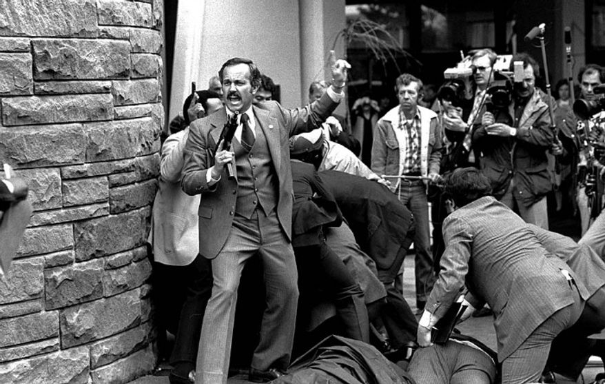 A Secret Service agent shouts after President Ronald Reagan is shot March 30, 1981. (Associated Press)
