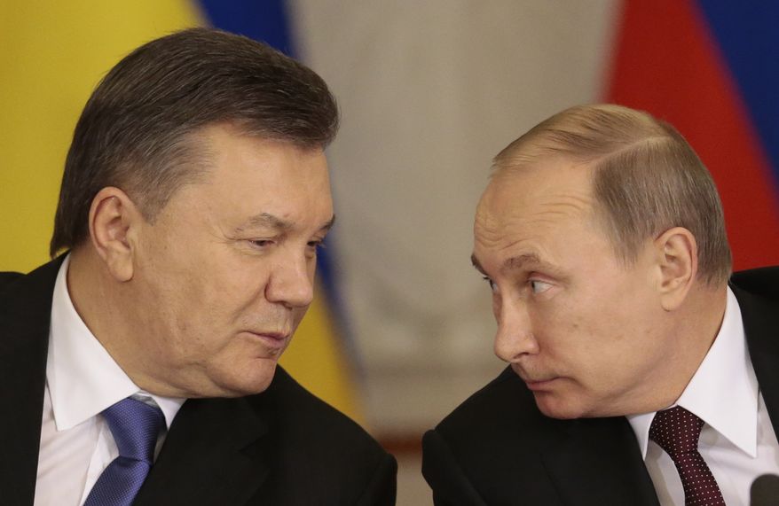 ** FILE ** In this Tuesday Dec. 17, 2013, file photo, Russian President Vladimir Putin, right, and his Ukrainian counterpart Viktor Yanukovych talk during a news conference in Moscow. Moscow on Wednesday granted Ukrainian President Viktor Yanukovych protection "on the territory of Russia," shortly after the fugitive leader sought help from the Kremlin, according to an official quoted by Russian news agencies. (AP Photo/Ivan Sekretarev, file)