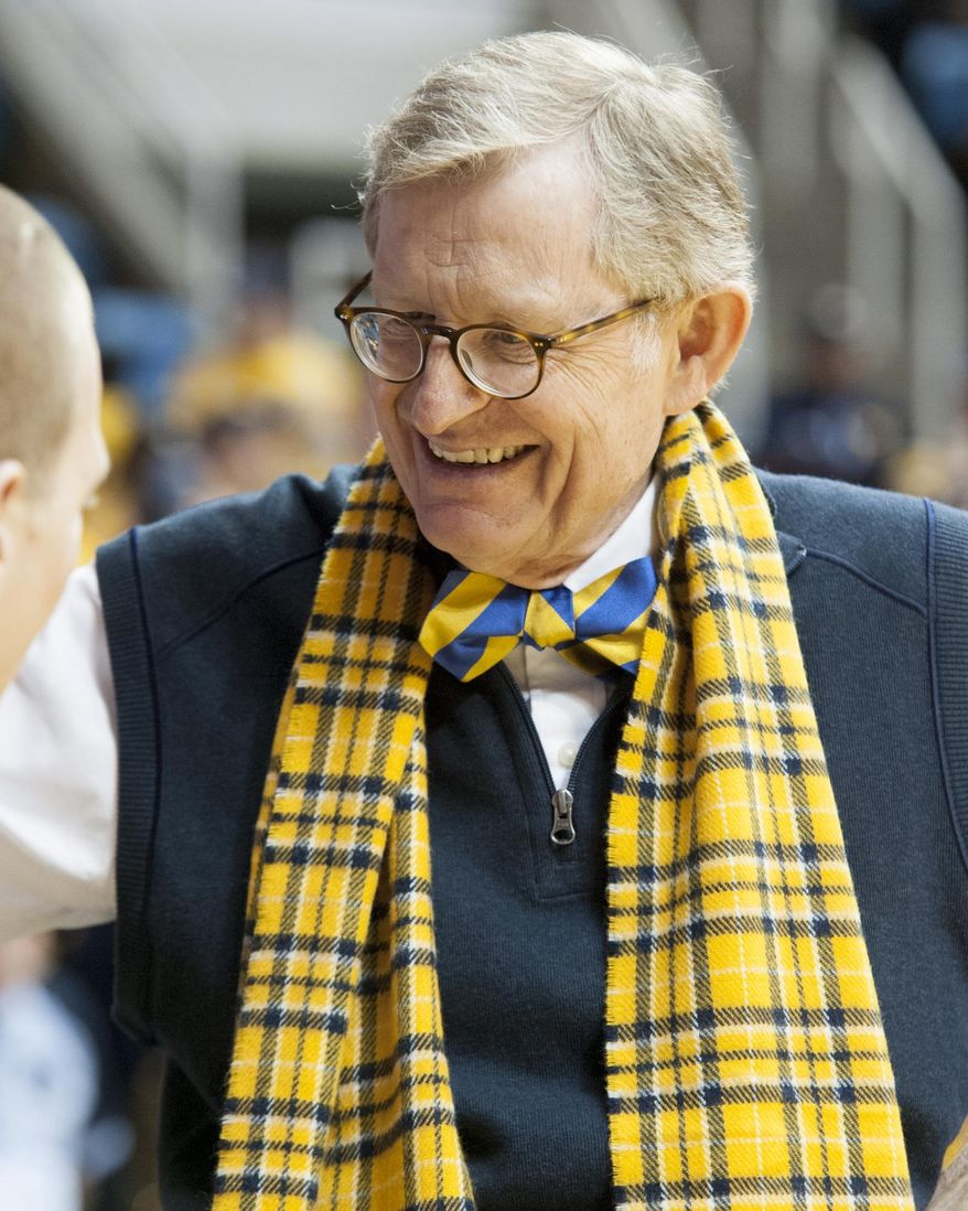 FILE - In this Jan. 11, 2014 file photo, West Virginia's interim president Gordon Gee greets a fan before an NCAA college basketball game between West Virginia and Oklahoma State in Morgantown, W.Va. A West Virginia University search committee on Friday, Feb. 28, 2014, did an about-face and endorsed interim President E. Gordon Gee for the job permanently. The committee made the recommendation during an emergency meeting in Morgantown. The recommendation now goes to the WVU Board of Governors. (AP Photo/Andrew Ferguson)
