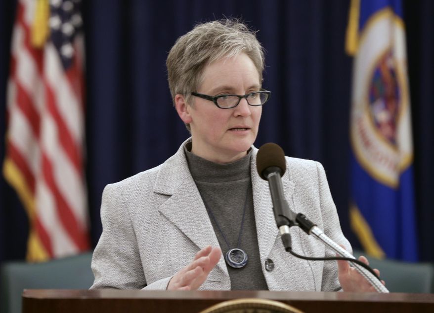State Budget Director Margaret Kelly talks about the state's budget forecast, Friday, Feb. 28, 2014 in St. Paul, Minn. Minnesota's projected budget surplus swelled to $1.233 billion, giving lawmakers more leeway to pursue tax cuts and increased spending this session. (AP Photo/Jim Mone)