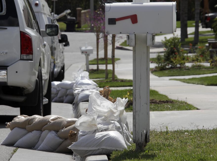 Sandbags line a street considered especially at risk in Azusa, Calif., as the city makes preparations for possible flooding Thursday, Feb. 27, 2014. In advance of a powerful Pacific storm, mandatory evacuation orders have been issued for 1,000 homes in Glendora and Azusa, two of Los Angeles' eastern foothill suburbs, which are located beneath nearly 2,000 acres of steep mountain slopes left bare by a January fire. (AP Photo/Reed Saxon)
