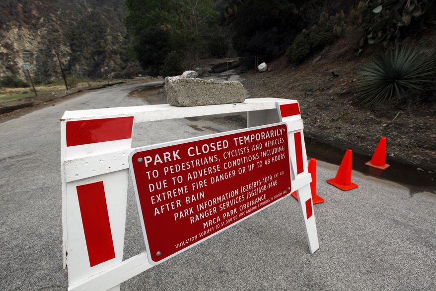 River Wilderness Park in San Gabriel Canyon is temporarily closed, one of several areas considered especially at risk in Azusa, Calif., as the city prepares for possible flooding Thursday, Feb. 27, 2014. Mandatory evacuation orders have been issued for 1,000 homes in two foothill suburbs east of Los Angeles in advance of a powerful storm. The cities of Glendora and Azusa issued the orders at midday Thursday for homes that could be endangered by debris flows from nearly 2,000 acres (810 hectares) of steep mountain slopes burned by a wildfire last month. For days, both cities have been making extensive preparations including sandbagging. California received widespread rain Wednesday and early Thursday from the first of two back-to-back storms. The more powerful second storm is due overnight. (AP Photo/Reed Saxon)