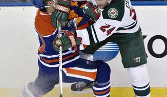Minnesota Wild&#39;s Matt Cooke (24) checks Edmonton Oilers&#39; Andrew Ference (21) during second period NHL hockey action in Edmonton, Canada, Thursday, Feb. 27, 2014. (AP Photo/The Canadian Press, Jason Franson)