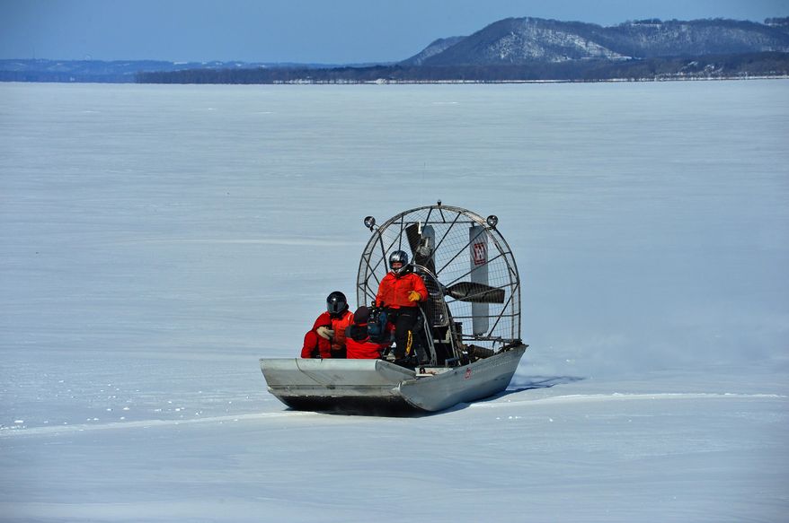In this photo taken on Thursday, Feb. 27, 2014, U.S. Army Corps of Engineers use airboats to travel along the Lake Pepin section of the Mississippi River near Wabasha, Minn., to survey the thinkness of the ice covering the ricer. The survey, the first one of the year, is part of the Corps’ task of maintaining and monitoring the river’s navigation system, which is vital to the Upper Midwest’s economy. The weekly results are tracked by river shippers eager to get to work for the new season. (AP Photo/The Star Tribune, Richard.Sennot) MANDATORY CREDIT; ST. PAUL PIONEER PRESS OUT; MAGS OUT; TWIN CITIES TV OUT