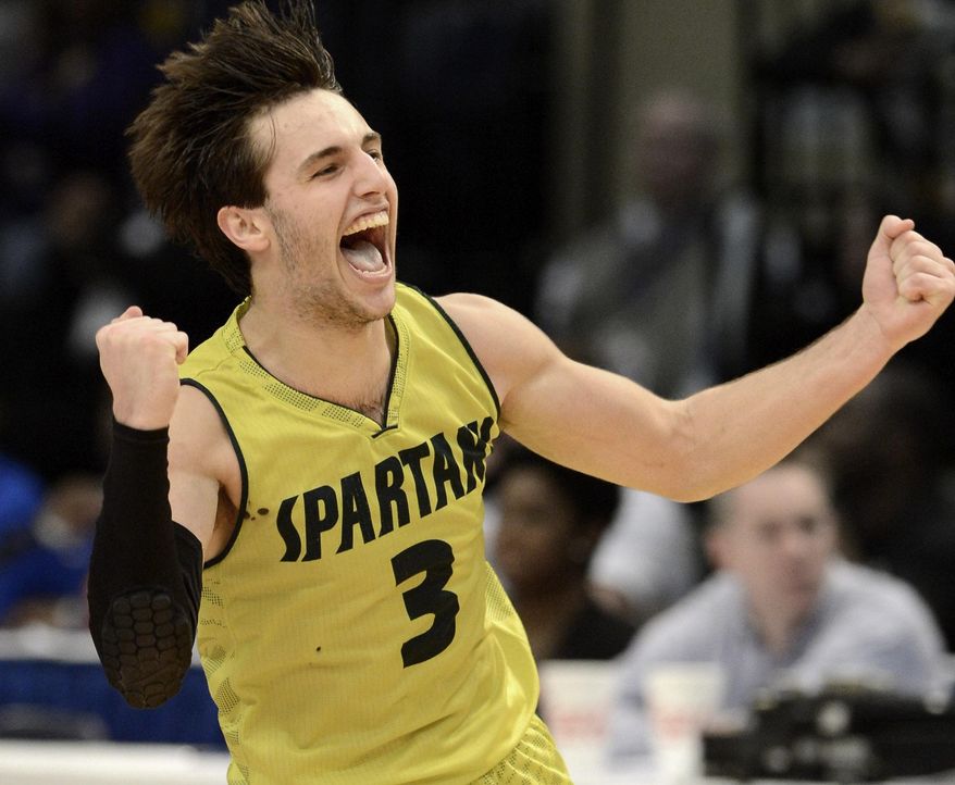 Mountain Brook's Patrick Keim celebrates the 60-57 victory over Blount in the AHSAA boys' Class 6A state basketball championship game in Birmingham, Ala., Friday, Feb. 28, 2014. (AP Photo/AL.com, Mark Almond) MAGS OUT