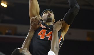 Oregon State forward Devon Collier, top, goes up for a shot as USC guard Byron Wesley defends during the first half of an NCAA college basketball game, Thursday, Feb. 27, 2014, in Los Angeles. (AP Photo/Mark J. Terrill)