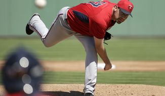 Minnesota Twins pitcher Mike Pelfrey, follows through on a warm-up throw in the first inning of an exhibition baseball game against the Boston Red Sox, Friday, Feb. 28, 2014, in Fort Myers, Fla. (AP Photo/Steven Senne)