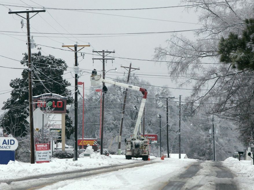 FILE - In this Feb. 13, 2014, file photo, a utiilites crew works to repair lines off highway 176 in Chapin, S.C., during the worst winter storm in the state in a decade. A state emergency official said Friday, Feb. 28, 2014 that, while figures are still being compiled, damage from the storm will likely qualify sections of the state for designation as a federal disaster area - the first such designation in almost a decade. (AP Photo/Mary Ann Chastain, File)
