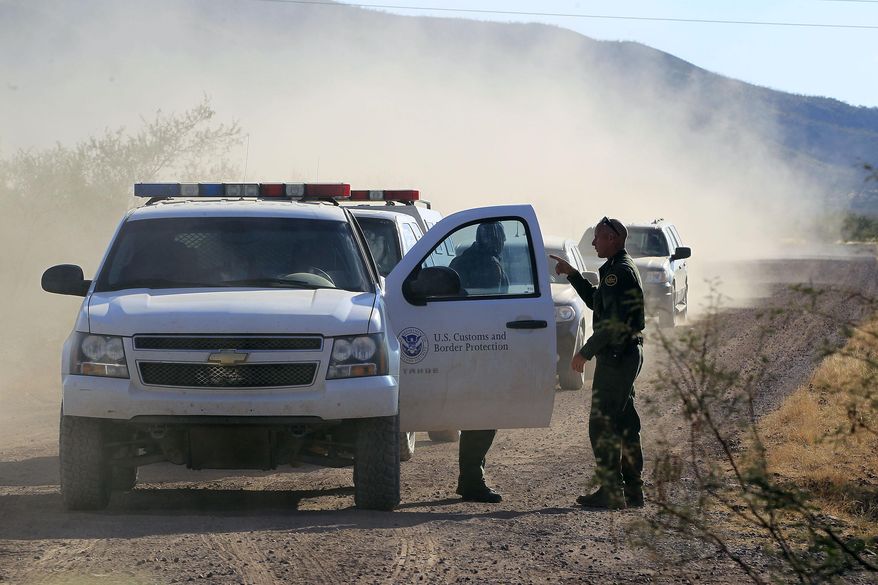 FILE - In this Oct. 2, 1012 file photo, U.S. Customs and Border Protection officers and other law enforcement jurisdictions drive the roads near near Bisbee, Ariz. New Homeland Security Secretary Jeh Johnson is reviewing the department’s use of force policies, a Homeland Security official said Friday. The official said Johnson has been reviewing the rules about when agents along the border can use their guns since he took office in December. (AP Photo/Ross D. Franklin, file)