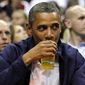 **FILE**  In this July 16, 2012 file photo, President Barack Obama sips his beer as he watches Team USA and Brazil during the first half of an Olympic men&#39;s exhibition basketball game, in Washington. (AP Photo/Alex Brandon, File)