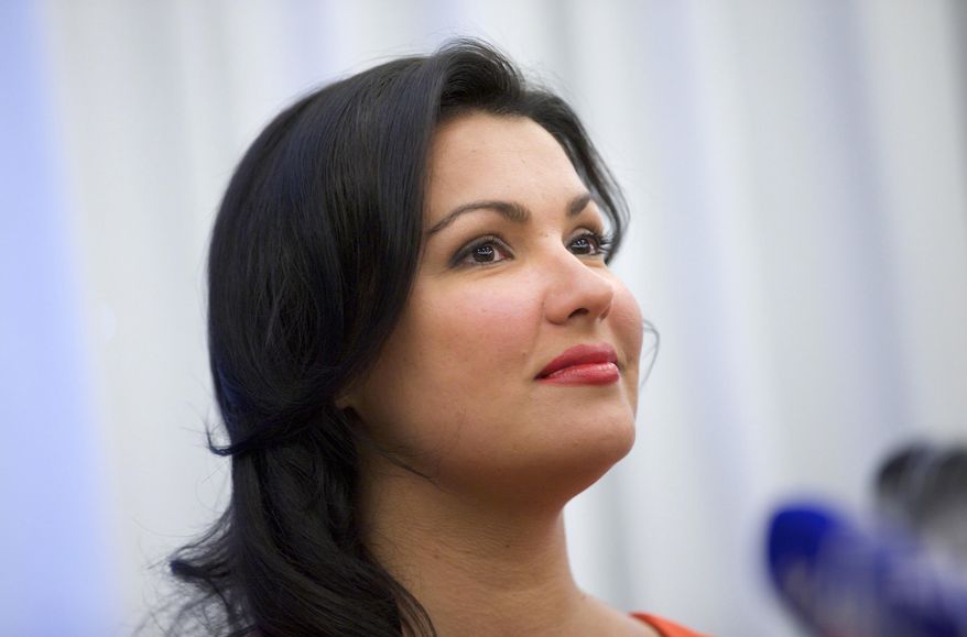 In this picture taken June 18, 2013, Russian leading operatic soprano Anna Netrebko speaks at a news conference in Moscow, Russia. Netrebko has pulled out of plans to play Marguerite in Charles Gounod’s “Faust,” saying she’s decided that the role isn’t right for her. The soprano was due to play the part at London’s Royal Opera House, in Vienna and in Baden-Baden, Germany later this year. However, she said in a statement Friday, Feb. 28, 2014, “after much consideration and intensive preparation, I have come to the conclusion that the role is not right for me.” (AP Photo/Ivan Sekretarev)