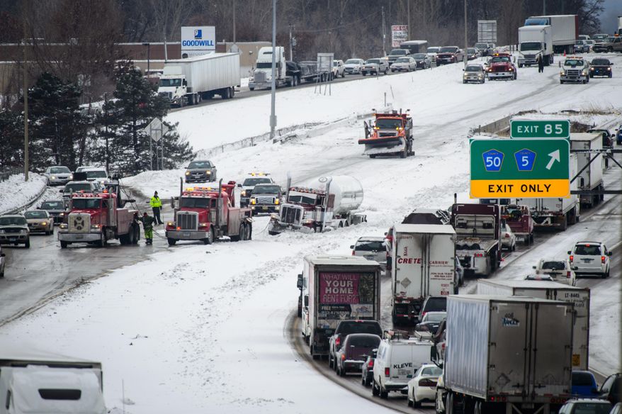 Traffic slows after authorities closed a section of Interstate 35 in Lakeville, Minn., Friday, Feb. 28, 2014. A series of pileups in snowy weather closed the stretch of highway for several hours Friday. (AP Photo/The Star Tribune, Glen Stubbe) MANDATORY CREDIT; ST. PAUL PIONEER PRESS OUT; MAGS OUT; TWIN CITIES TV OUT MBO TV is soft out
