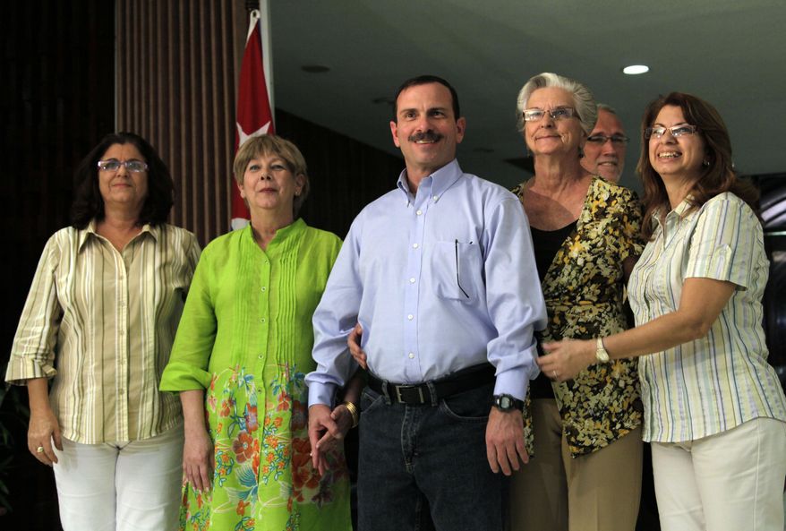 Fernando Gonzalez poses with family members after his arrival at the Jose Marti International Airport in Havana, Cuba, Friday, Feb. 28, 2014. A second member of the "Cuban Five," Gonzalez returned to the Caribbean island to a hero's welcome Friday, a day after leaving a prison in the United States, where he spent 15 years behind bars on spy-related charges. (AP Photo/Ismael Francisco, Cubadebate)