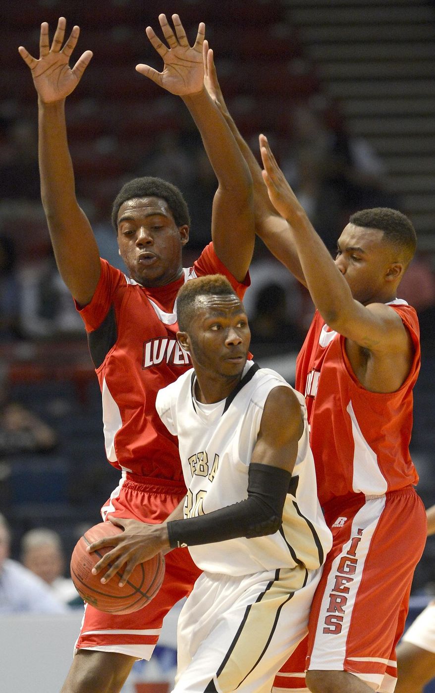 Elba's Denzell Thomas looks for help as Luverne's DeAnthony Rutledge, left, and Preston Sankey defend during the AHSAA boys' Class 2A state basketball championship game in Birmingham, Ala., Friday, Feb. 28, 2014. Elba won 66-61. (AP Photo/AL.com, Mark Almond) MAGS OUT