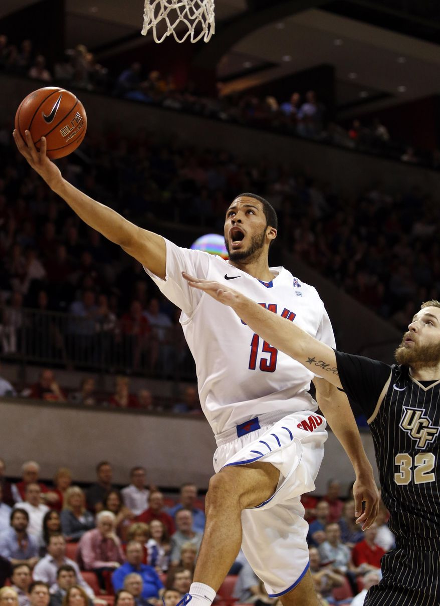 SMU center Cannen Cunningham (15) takes the ball past Central Florida forward Kasey Wilson (32) to the basket during the first half of an NCAA college basketball game on Saturday, March 1, 2014, in Dallas. (AP Photo/John F. Rhodes)