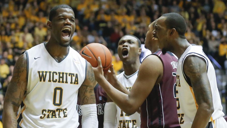 Wichita State's Chadrack Lufile (0) celebrates getting fouled by Missouri State's Devon Thomas, at center right with the ball, with teammates Cleanthony Early, middle and Nick Wiggins during the first half of an NCAA college basketball game in Wichita, Kan., Saturday, March 1, 2014. (AP Photo/The Wichita Eagle, Travis Heying) LOCAL TV OUT; MAGS OUT; LOCAL RADIO OUT; LOCAL INTERNET OUT