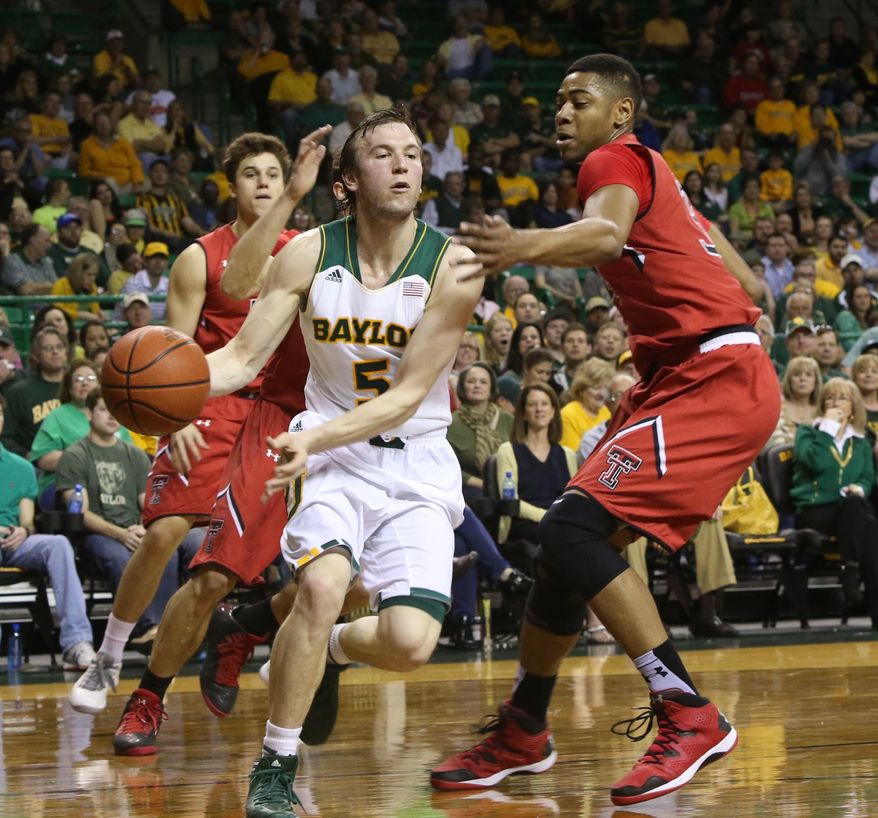 Baylor guard Brady Heslip (5) is pressured by Texas Tech Jordan Tolbert (32) during the first half of an NCAA college basketball game, Saturday, March, 1, 2014, in Waco, Texas. (AP Photo/Waco Tribune Herald, Michael Bancale)