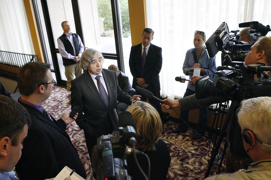 FILE - In this June 19, 2013 file photo, U.S. Energy Secretary Ernest Moniz, center left, answers questions from reporters in Richland, Wash., before touring the Hanford Nuclear Reservation. Documents obtained by the Associated Press show that there are “significant construction flaws” in some newer, double-walled storage tanks at the nuclear waste complex and in a letter Moniz, Friday, Feb. 28, 2014, Sen. Ron Wyden, D-Ore., called for better management of Hanford by the Dept. of Energy. (AP Photo/The Tri-City Herald, Kai-Huei Yau, file) LOCAL TV OUT; LOCAL RADIO OUT KONA