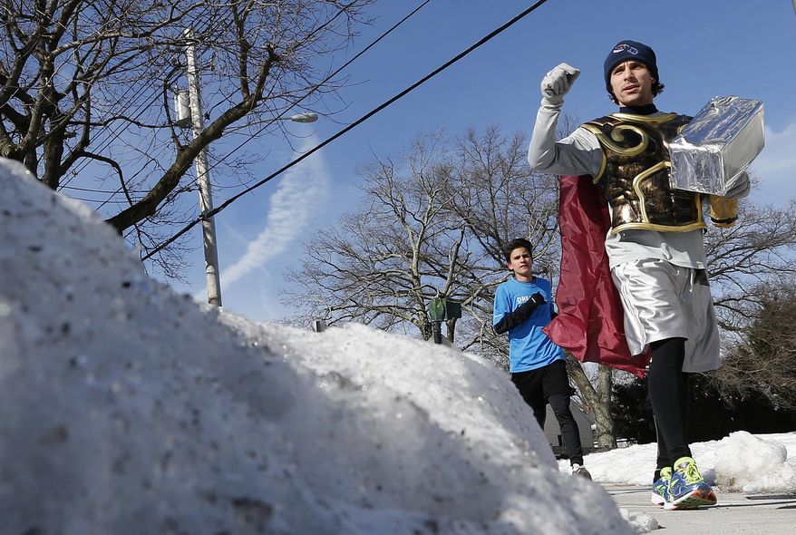 Runners in costume train for the Boston Marathon in Newton, Mass., Saturday, March 1, 2014. People running this year's Boston Marathon for charity gathered for a 17-mile training run along the last 17 miles of the course. (AP Photo/Michael Dwyer)