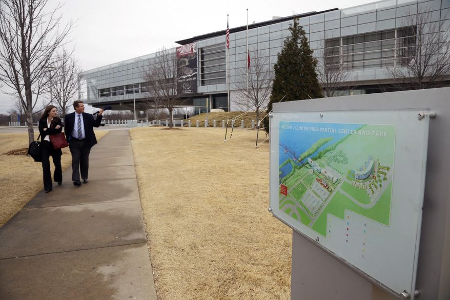Visitors walk from the Clinton Presidential Library in Little Rock, Ark., Friday, Feb. 28, 2014. The National Archives released about 4,000 pages of previously confidential documents Friday involving the former president's administration. (AP Photo/Danny Johnston)