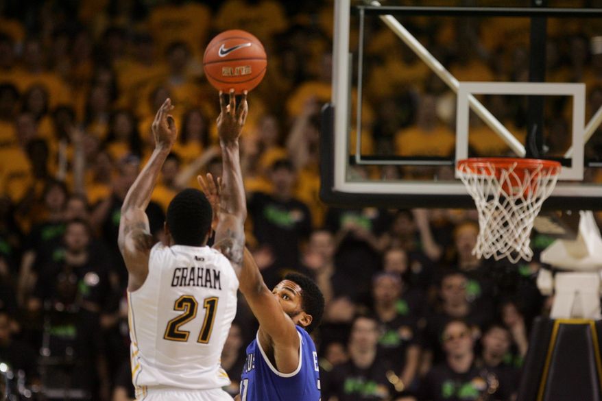 Saint Louis' Dwayne Evans defends a shot by VCU's Trevon Graham (21) in the first half of an NCAA college basketball game on Saturday, March 1, 2014, in Richmond, Va. (AP Photo/Jason Hirschfeld)