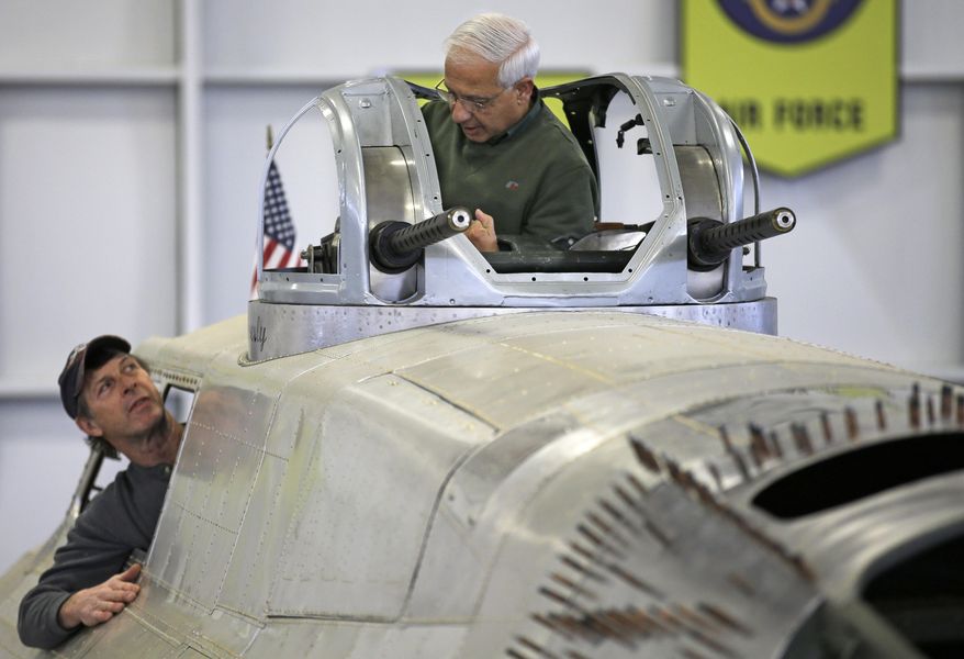 Volunteers Shonil Datta, right, and Rob Culbertson work on a gun turret of a B-17 World War II-era bomber being built from salvaged and fabricated parts at the Champaign Aviation Museum in Urbana, Ohio on Thursday, Feb. 20, 2014. The project started in 2005 and is still years away from completion. (AP Photo/Al Behrman)