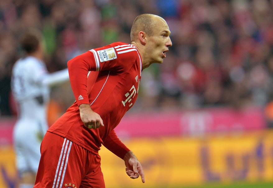 Bayern's Arjen Robben of the Netherlands celebrates after scoring, during the German first division Bundesliga soccer match between FC Bayern Munich and FC Schalke in Munich, Germany, on Saturday, March 1. 2014. (AP Photo/Kerstin Joensson)