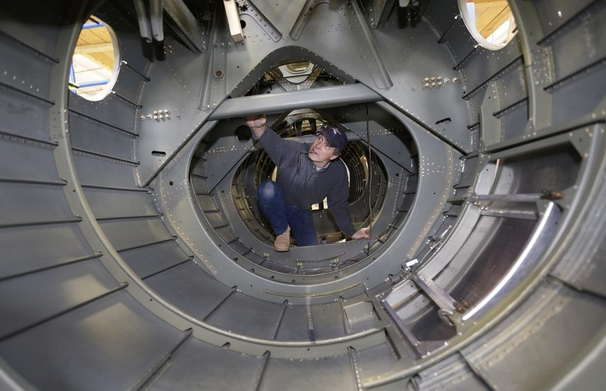 Volunteer Ron Culbertson works inside the tail section of a B-17 World War II-era bomber being built from salvaged and fabricated parts at the Champaign Aviation Museum in Urbana, Ohio on Thursday, Feb. 20, 2014. The project started in 2005 and is still years away from completion. (AP Photo/Al Behrman)
