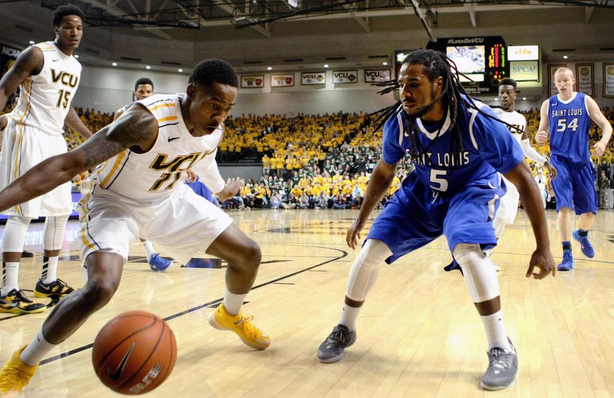 Saint Louis's Jordair Jett, right, and Virginia Commonwealth's Rob Brandenberg, left, battle for a loose ball in the first half of an NCAA college basketball game, Saturday, March 1, 2014 in Richmond, Va. (AP Photo/Jason Hirschfeld)