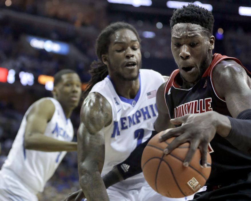 Louisville's Montrezl Harrell, right, is pressured by Memphis' Shaq Goodwin, center, in the first half of an NCAA college basketball game in Memphis, Tenn., Saturday, March 1, 2014. (AP Photo/Danny Johnston)