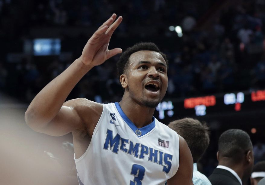 Memphis' Chris Crawford celebrates his team's 72-66 victory over Louisville after an NCAA college basketball game in Memphis, Tenn., Saturday, March 1, 2014. (AP Photo/Danny Johnston)