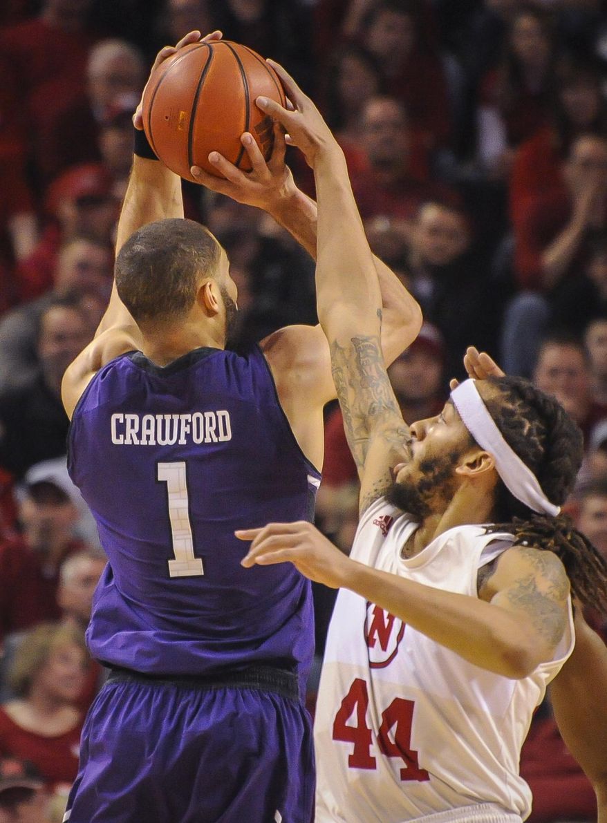 Nebraska's Terran Petteway (44) blocks a shot by Northwestern's Drew Crawford (1) during an NCAA college basketball game Saturday, March 1, 2014, in Lincoln, Neb. (AP Photo/Dave Weaver)