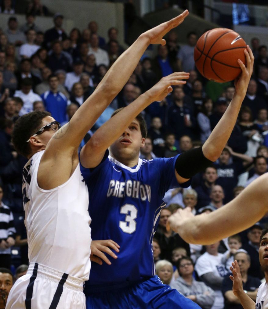 Creighton's Doug McDermott shoots past Xavier's Isaiah Philmore during the first half of an NCAA college basketball game in Cincinnati on Saturday, March 1, 2014. (AP Photo/Tom Uhlman)