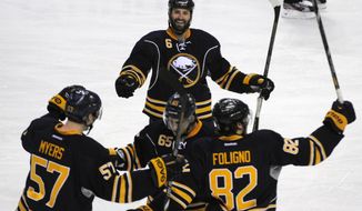 Buffalo Sabres&#39; Tyler Myers (57) Brian Flynn (65), Mike Weber (6) and Marcus Foligno (82) celebrate a goal by Flynn during the third period of an NHL hockey game against the San Jose Sharks in Buffalo, N.Y., Friday, Feb. 28,  2014. Buffalo won 4-2. (AP Photo/Gary Wiepert)