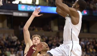Wake Forest guard Codi Miller-McIntyre (0) shoots over Boston College guard Olivier Hanlan (21) during the first half of an NCAA college basketball game in Winston-Salem, N.C., Saturday, March 1, 2014. (AP Photo/The Journal, Bruce Chapman)