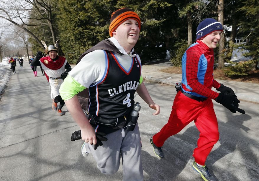 Runners in costume train for the Boston Marathon in Newton, Mass., Saturday, March 1, 2014. People running this year's Boston Marathon for charity gathered for a 17-mile training run along the last 17 miles of the course. (AP Photo/Michael Dwyer)