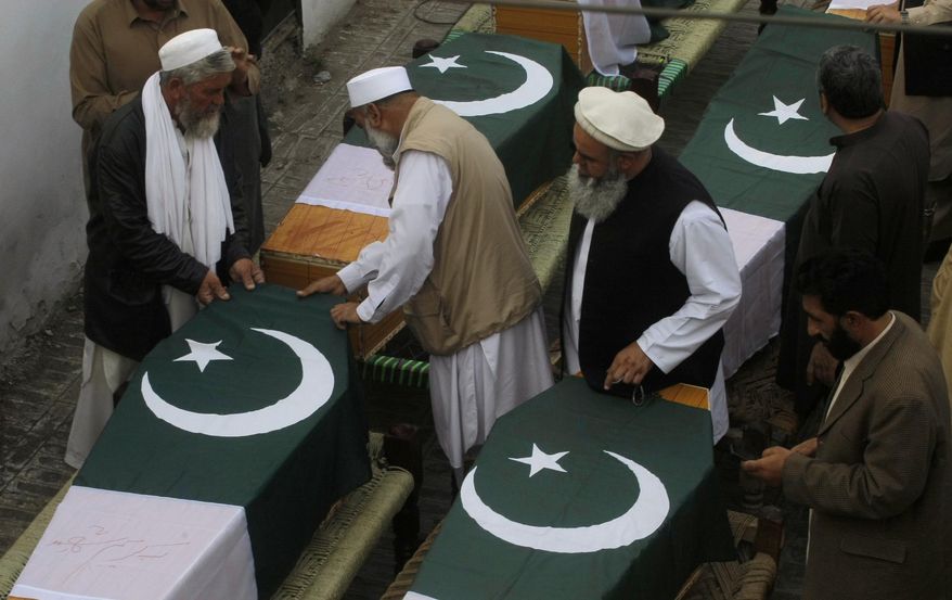 Pakistani relatives of police officers who were killed in Saturday bomb blasts prepare their caskets during their funeral, in Jamrud, near Peshawar, Pakistan, Saturday, March 1, 2014. The Pakistani Taliban announced Saturday that the group will observe a one-month cease-fire as part of efforts to negotiate a peace deal with the government, throwing new life into a foundering peace process. The violence Saturday showed how difficult it could be to enforce a cease-fire, let alone forge a peace agreement. (AP Photo/Mohammad Sajjad)