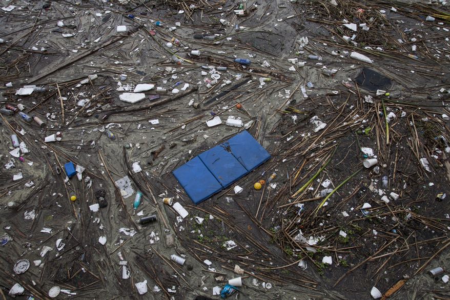 Trash collects along the shore after after a rainstorm in Long Beach, Calif. on Saturday, March 1, 2014. (AP Photo/Ringo H.W. Chiu)