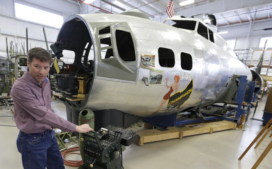 Dave Shiffer displays a throttle quadrant that will be placed in the B-17 World War II-era bomber being built from salvaged and fabricated parts at the Champaign Aviation Museum in Urbana, Ohio on Thursday, Feb. 20, 2014. Shiffer, whose ride aboard a touring B-17 with his father and brother in 2005 eventually led to the B-17 project and the subsequent founding of the nonprofit museum. (AP Photo/Al Behrman)