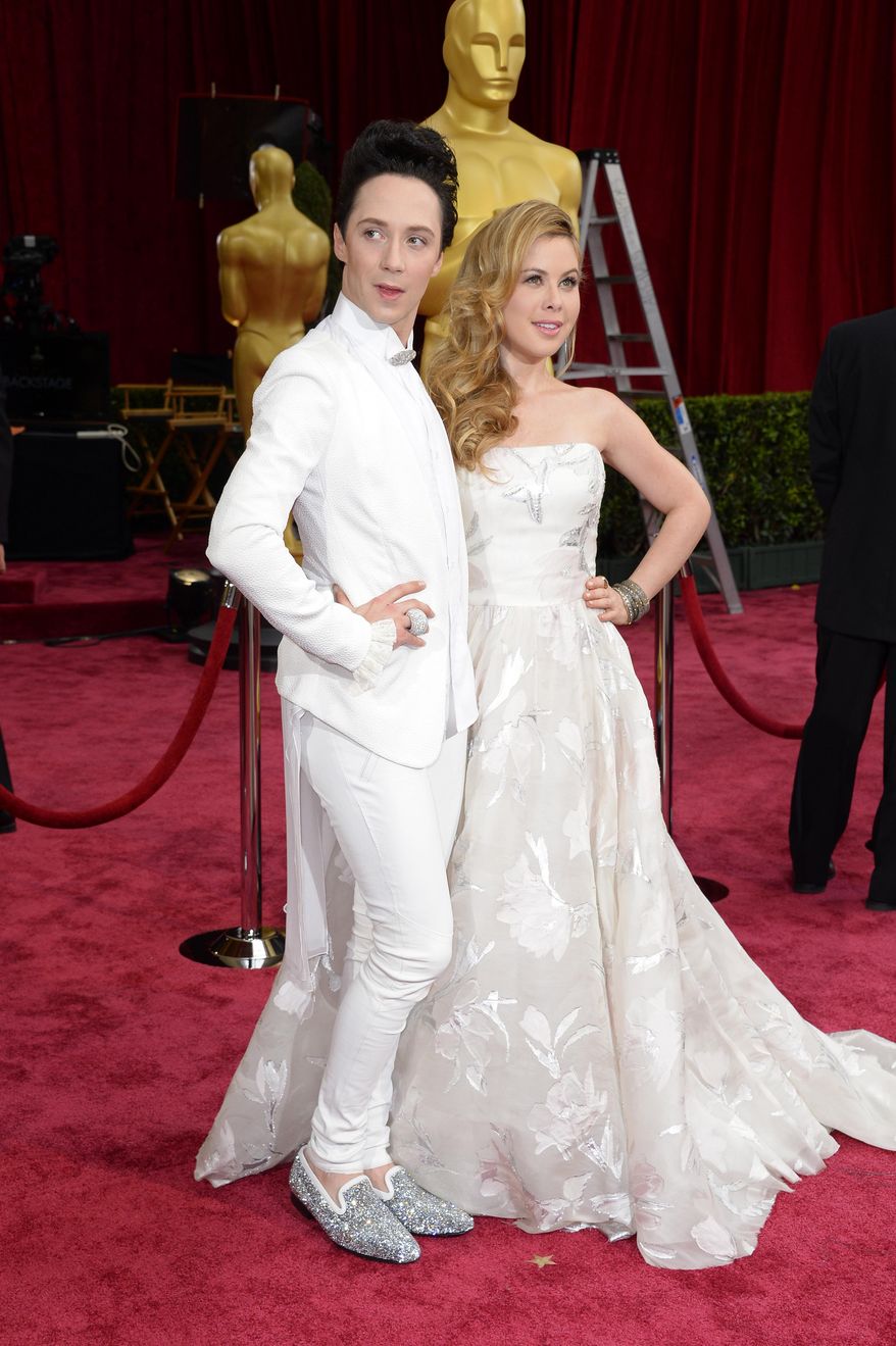 Johnny Weir, left, and Tara Lipinski arrive at the Oscars on Sunday, March 2, 2014, at the Dolby Theatre in Los Angeles. (Photo by Dan Steinberg/Invision/AP)