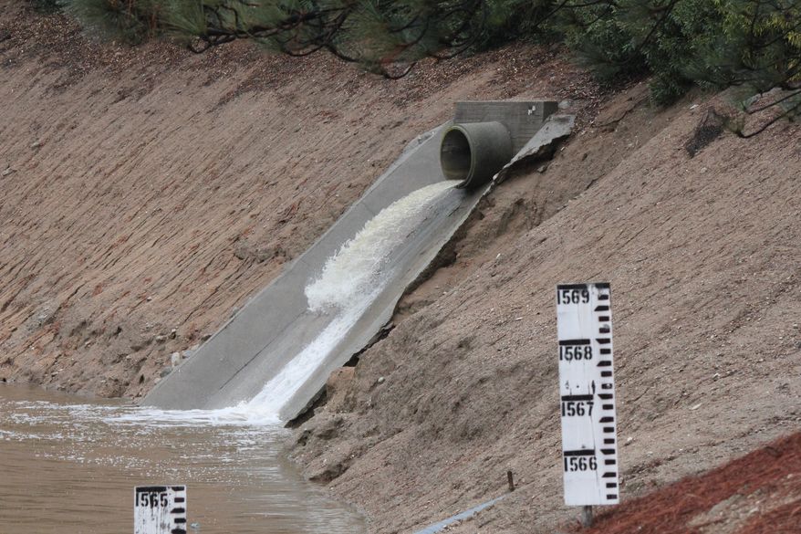 Storm water flows into a debris basin in Altadena, Calif., as thunderstorms dump rain on the San Gabriel Mountains on Saturday, March 1, 2014. Residents of some 1,200 homes in three foothill cities to the east were under evacuation orders due to danger of debris flows from steep slopes burned bare by recent wildfires. (AP Photo/ John Antczak)