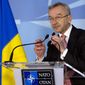 Ukraine&#x27;s Ambassador to NATO Ihor Dolhov adjusts the microphones prior to speaking during a media conference at NATO headquarters in Brussels on Sunday, March 2, 2014. NATO is called emergency talks on Sunday regarding the escalating crisis in Ukraine. (AP Photo/Virginia Mayo)