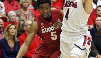 Stanford&#39;s Chasson Randle (5) works around Arizona&#39;s T.J. McConnell (4) during the first half of an NCAA college basketball game Sunday, March 2, 2014, in Tucson, Ariz. (AP Photo/John MIller)