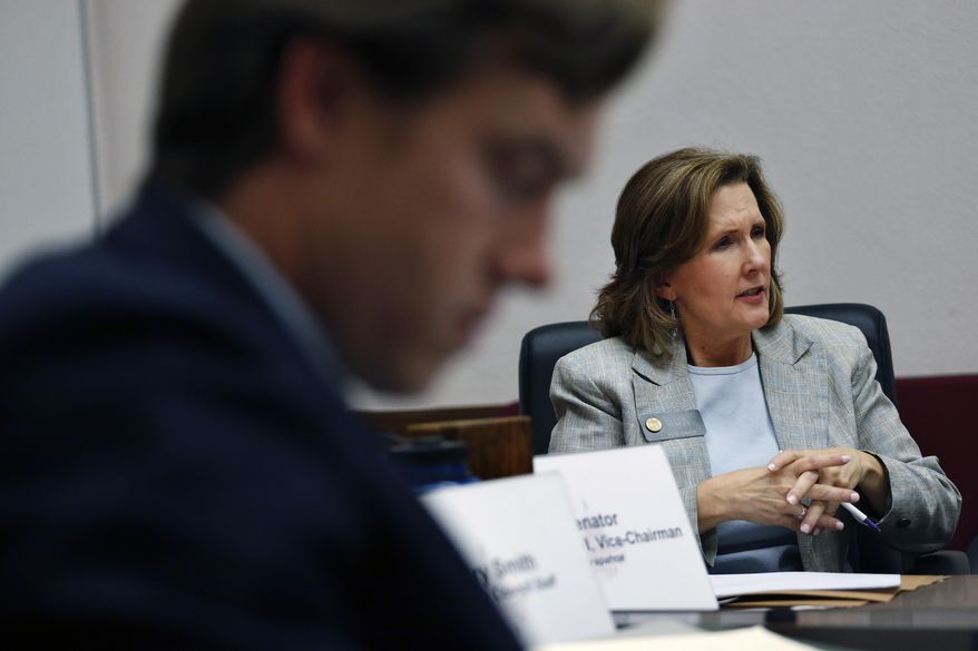 FILE - In this Jan. 15, 2014 file photo, Colorado state Democratic Senator Linda Newell listens to testimony during a committee hearing at the Capitol, in Denver. Newell of Littleton is sponsoring a bill to require private investigators in Colorado to get state licenses, a requirement in 44 states and a safeguard against unscrupulous PIs. (AP Photo/Brennan Linsley, File)