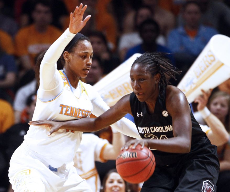 South Carolina forward Aleighsa Welch (24) drives against Tennessee forward Bashaara Graves in the first half of an NCAA college basketball game on Sunday, March 2, 2014, in Knoxville, Tenn. (AP Photo/Wade Payne)